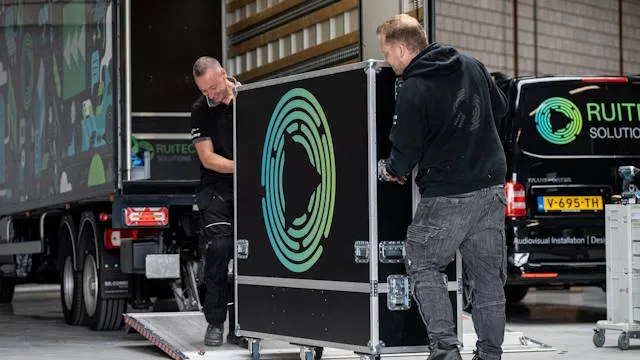 Employees loading a lorry