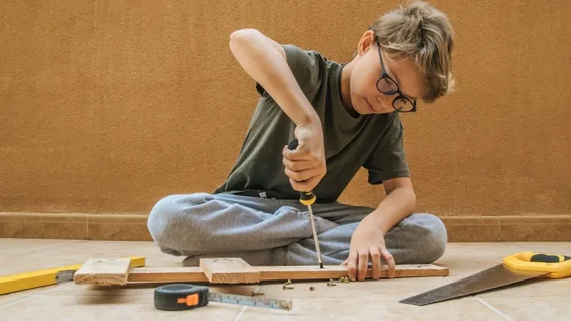 little boy working with carpentry tools