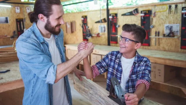 father and son working together with wood