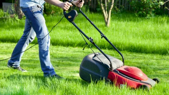 man mowing lawn with electric lawn mower