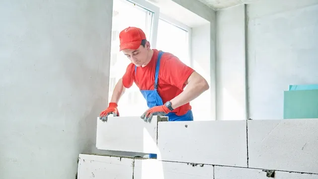 man verlijmt gastbetonblokken