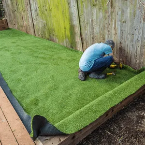 man installs artificial grass